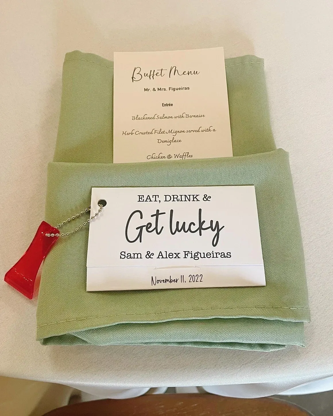 A green napkin with a card and some other things