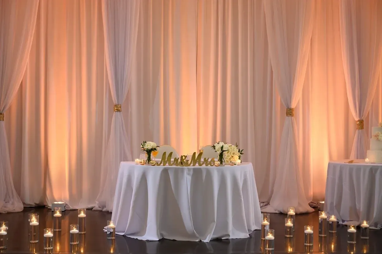 A table with candles and a white cloth